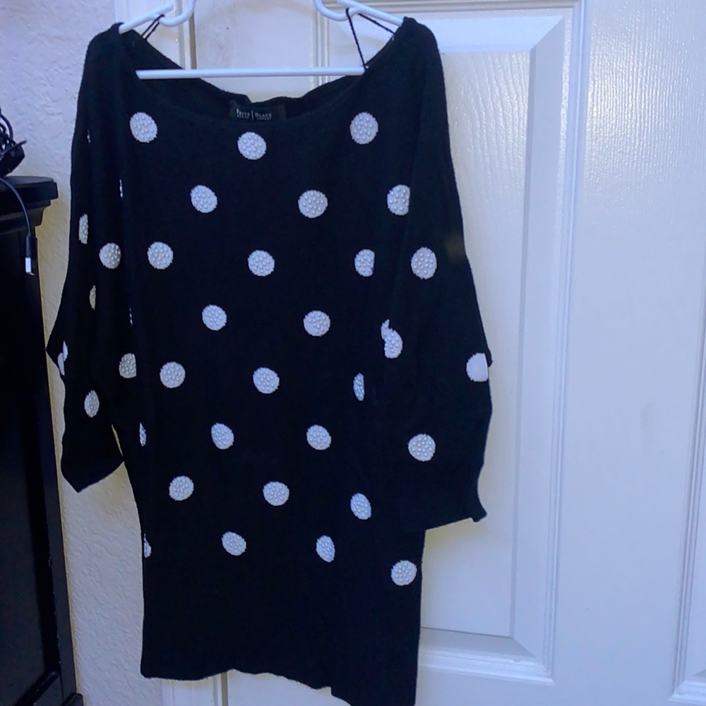 I’m selling a sweater that is all black with white poke a dots barely worn